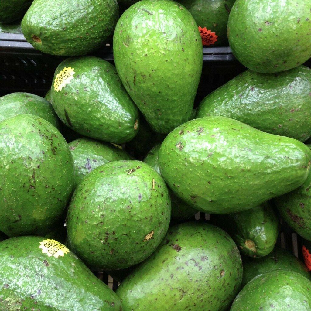 Fresh avocados are pear-shaped fruits known for their creamy texture and rich
